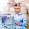 demo-attachment-146-Hipster-manager-in-cafe-working-on-laptop-by-window